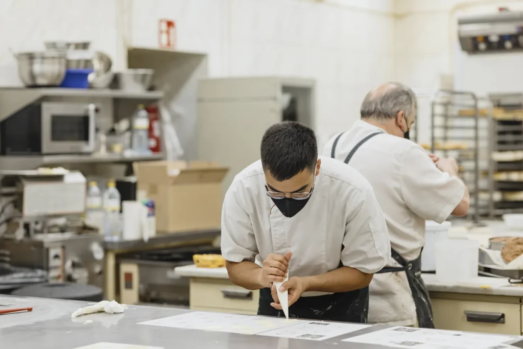 Bakers training in a government bakery course kitchen