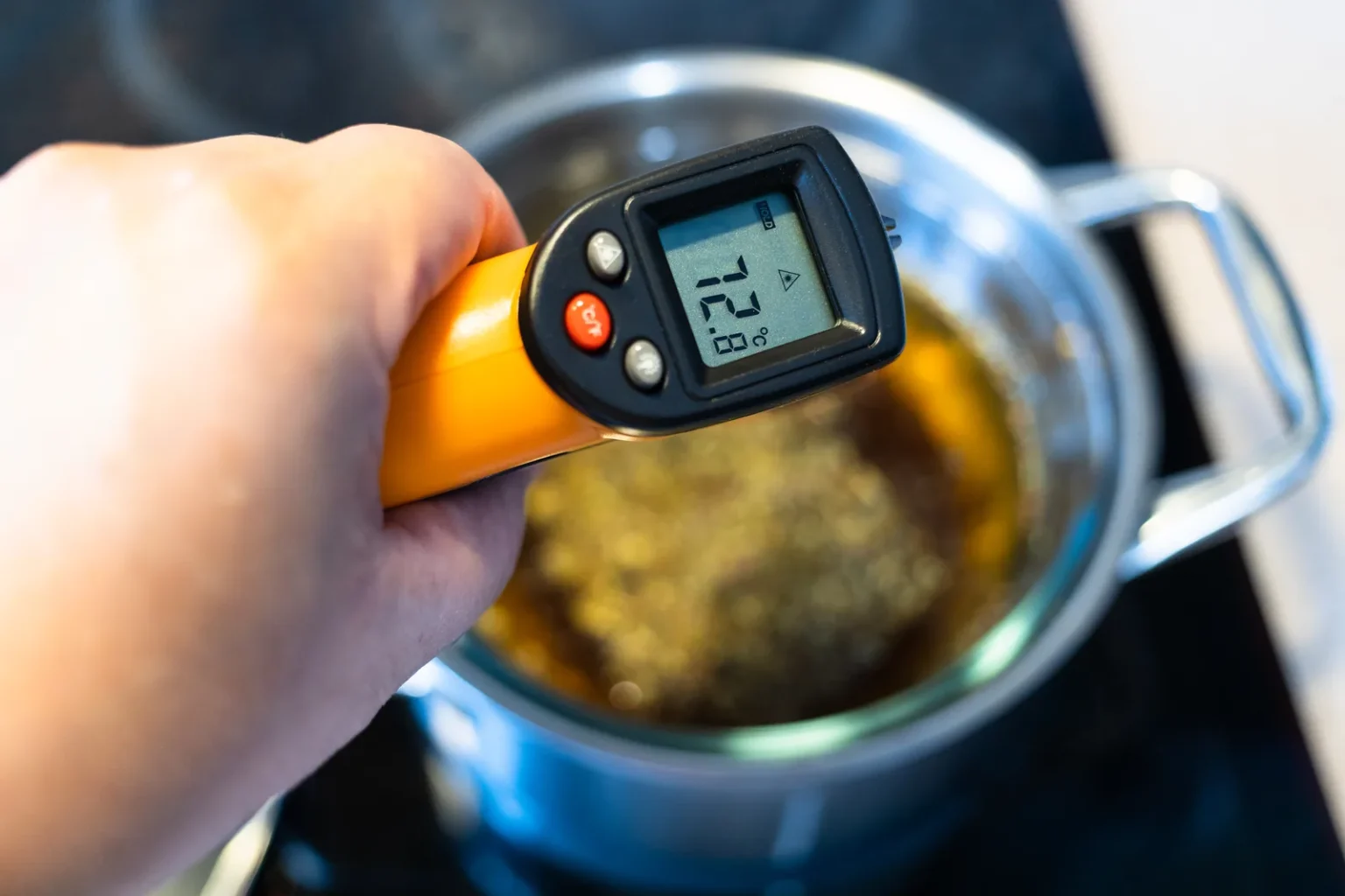 7 principles of HACCP: chef checking food temperature with an infrared thermometer