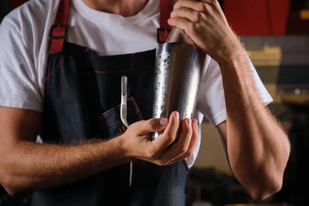Best bartending course in India: bartender mixing cocktails in a professional bar